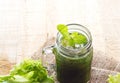 Fresh smoothie detox diet lettuce with mint on sack and wooden background