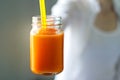 Fresh smoothie detox vegetable carrot in hand on vintage color tone style