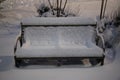 Snow covered park bench Royalty Free Stock Photo