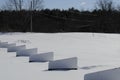 fresh snow covering golf driving range, dividers partially buried