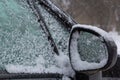 fresh snow covers the surroundings and the car mirror, snow texture on a metal surface, winter Royalty Free Stock Photo