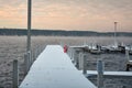 Snow Covered Dock With Lifebuoy Mist rising from the Lake