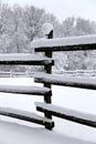 Fresh snow filled corral fences at rural winter snowy horse farm