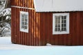 Fresh snow giving a mantle to a beautiful playhouse and trees in the garden