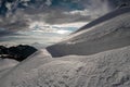 Fresh snow lying on a smooth mountain side