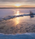 Snow on the shore, lake bound by ice and snow at sunset in winter, Vuoksa, Leningrad region