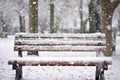 fresh snowfall on aged sheet music on a park bench Royalty Free Stock Photo