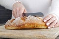 a fresh soft loaf of bread cut into pieces with a knife Royalty Free Stock Photo