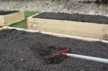 Leveling out the soil in a backyard garden box Royalty Free Stock Photo