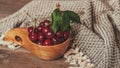 Fresh sour cherries in wooden bowl on rustic background Royalty Free Stock Photo