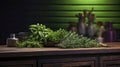 Fresh spices rosemary, mint, basil and other aromatic herbs are lying on wooden table on dark background.