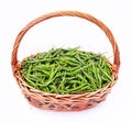 Fresh and spicy green chili peppers in rattan basket