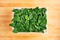Fresh spinach leaves in wooden box Royalty Free Stock Photo