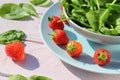 Fresh spinach salad with spinach and strawberries on wooden light pink table Royalty Free Stock Photo