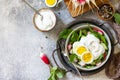 Fresh spring food, healthy vegan lunch bowl. Spinach, cucumber, radish salad and boiled eggs with sour cream. Top view flat lay. Royalty Free Stock Photo