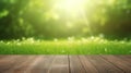 Fresh spring green grass with green bokeh and sunlight and wood floor. Beauty natural background Royalty Free Stock Photo