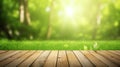 Fresh spring green grass with green bokeh and sunlight and wood floor. Beauty natural background Royalty Free Stock Photo