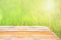 Fresh spring green grass with green bokeh and sunlight and wood floor. natural background. Copy-space for text Royalty Free Stock Photo