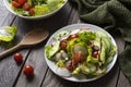 Fresh spring salad with lettuce, cucumber, cherry tomatoes, radishes, spring onion and avocado topped with balsamic glaze and