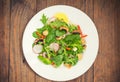 Fresh spring salad with radish, Mizuno, mushrooms grilled, Adygei cheese, spinach, bell pepper, lemon, corn. Wooden background