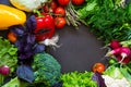 Fresh spring vegetables on black chalkboard