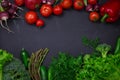 Fresh spring vegetables on black chalkboard