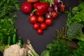 Fresh spring vegetables on black chalkboard