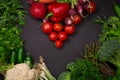 Fresh spring vegetables on black chalkboard