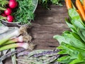Fresh Spring vegetables and herbs frame on rustic wood background. Spring harvest of fresh vegetables. Copy space Royalty Free Stock Photo