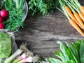 Fresh Spring vegetables and herbs frame on rustic wood background. Spring harvest of fresh vegetables. Copy space Royalty Free Stock Photo
