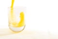 Fresh squeezed orange juice splashes into a glass tumbler Royalty Free Stock Photo