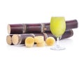 Fresh squeezed sugar cane juice in glass with cut pieces cane on white background Royalty Free Stock Photo