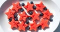 Fresh star shaped watermelon slices and blueberries on white plate Royalty Free Stock Photo