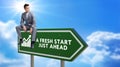 A Fresh Start Green Road Sign Against Clouds and Sunburst Royalty Free Stock Photo