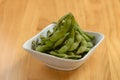 Fresh steamed edamame in a white bowl on wooden background top view Royalty Free Stock Photo