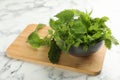 Fresh stinging nettle leaves on white marble table, closeup Royalty Free Stock Photo