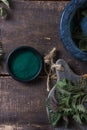 Fresh stinging nettle leaves on wooden table.Urtica dioica oil with spirulina powder, a healthy supplement to improve health