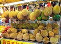 Fresh stinky durian fruit in a window display of a street Asian store