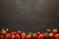 Fresh strawberries arranged on sleek slate background, vibrant colors