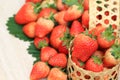Fresh strawberries in a baske on the wood table blurred natural green background with copy space Royalty Free Stock Photo