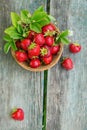 Fresh strawberries in a basket on rustic wooden background top view Royalty Free Stock Photo