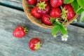 Fresh strawberries in a basket on rustic wooden background top view. Healthy food on wooden table mockup. Delicious, sweet, juicy Royalty Free Stock Photo