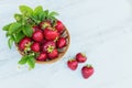 Fresh strawberries in a basket on rustic wooden background top view. Healthy food on white wooden table mockup. Delicious, sweet, Royalty Free Stock Photo