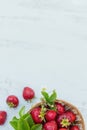 Fresh strawberries in a basket on rustic wooden background top view. Healthy food on white wooden table mockup. Delicious, sweet, Royalty Free Stock Photo