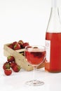 Fresh strawberries in basket and strawberry wine in glass Royalty Free Stock Photo