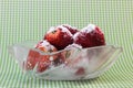 Fresh strawberries in a bowl decorated with sugar powder on top Royalty Free Stock Photo