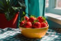 Fresh strawberries in a bowl on a sunny windowsill Royalty Free Stock Photo