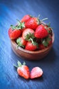 Fresh strawberries in a bowl on table, Red ripe strawberry on dark background