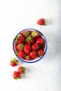 Fresh strawberries in bowl on white background. Top view. Royalty Free Stock Photo