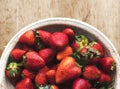 Fresh strawberries in a bowl on wooden table Royalty Free Stock Photo